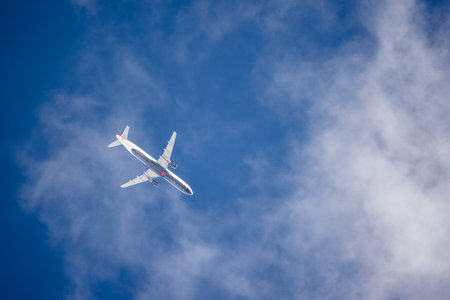 Toronto, Canada, 20 October 2025: Air Canada aircraft flying above clouds in blue skyのeditorial素材