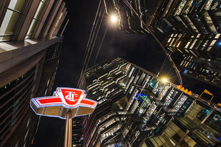 Toronto, Canada, 20 October 2025: A glowing TTC (Toronto Transit Commission) subway entrance sign...