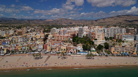 Aerial view of Villajoyosa beachfront with colorful houses promenade and Mediterranean coastline...
