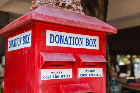 Red donation box for temple offerings at Wat Phra Yai Big Buddha temple on Koh Samui island in Thailand
