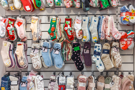 New-York, USA, 1 November 2025: Assorted colorful winter socks and cozy homewear displayed on retail...