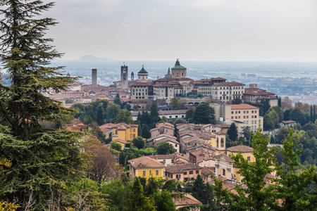 Panoramic view of Bergamo Citta Alta skyline with historic buildings and Italian landscape seen from hillside viewpoint