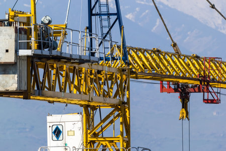 Construction crane on the background of the sky