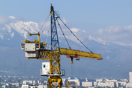 Construction crane on the background of the cityの写真素材
