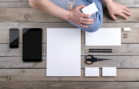Photo of branding identity mock up with a person. Template isolated on old wood background with girl. For graphic designers presentations and portfolios damaged weathered antique mock-up with manの写真素材