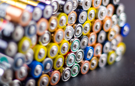 Battery AA texture background in a pile. Organized battery AA rows. Perspective view AA batteries texture. の写真素材