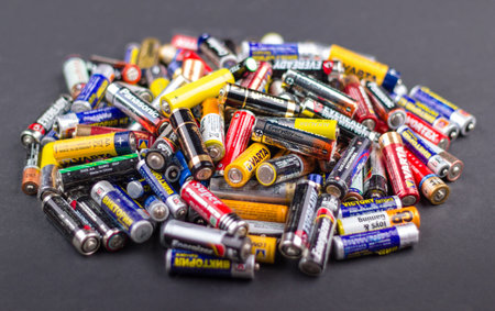 Bunch of AA batteries isolated in dark grey background, Kazakhstan, Almaty, April, 5, 2017.のeditorial素材