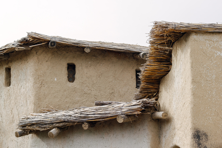 Ancient clay city. Tourist reconstruction. Thatched roofの写真素材