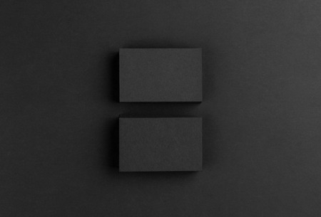 Photo of black business cards. Dark template isolated on black background. For graphic designers presentations and portfolios. Business card mock-up black ob black.の写真素材
