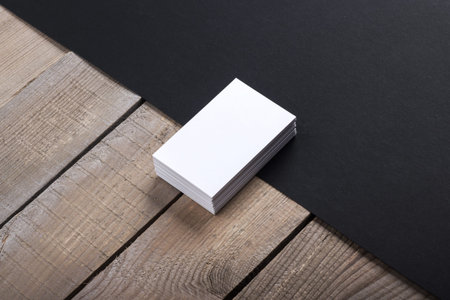 Photo of business cards. Template isolated on old wood background. For graphic designers...