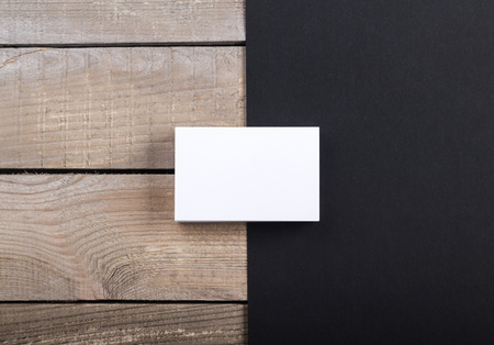 Photo of business cards. Template isolated on old wood background. For graphic designers presentations and portfolios damaged weathered antique mock-up with business cardsの写真素材