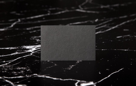 Photo of black business cards on marble. Template for branding identity isolated on marble background. For graphic designers presentations and portfolios. Marble premium luxury mock-up. Business card isolated on marble stone. Dark vintage business card mock-up.の写真素材
