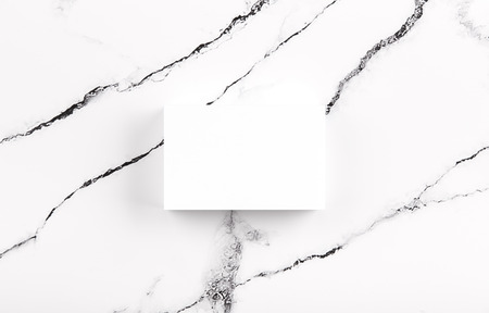 Photo of white business cards on white marble. Template for branding identity isolated on marble background. For graphic designers presentations and portfolios marble premium luxury mock-up. Business Card isolated on marble stone.の写真素材