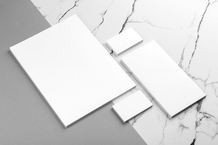Photo of branding identity mock up on white marble and gray background. Mock up isolated on marble backgroundの写真素材