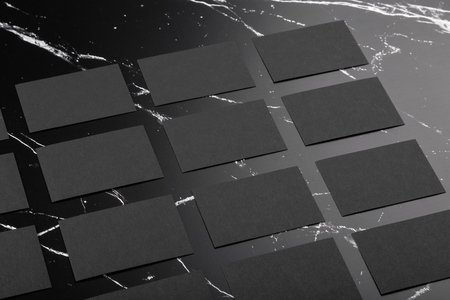 Photo of black business cards on black marble. Template for branding identity isolated on marble background. For graphic designers presentations and portfolios marble premium luxury mock-up. Business Card isolated on marble stone.の写真素材