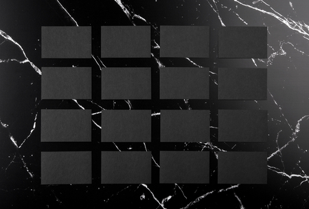 Photo of black business cards on black marble. Template for branding identity isolated on marble background. For graphic designers presentations and portfolios marble premium luxury mock-up. Business Card isolated on marble stone.の写真素材