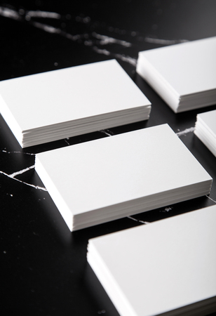 Photo of white business cards on black marble. Template for branding identity isolated on marble background. For graphic designers presentations and portfolios marble premium luxury mock-up. Business Card isolated on marble stone.の写真素材