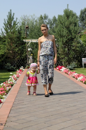 The girl and the child going on avenueの写真素材