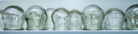 Jars for therapeutic massage on a white background stand in the salon on a shelf