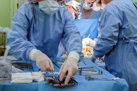 Surgical instruments in operating room on table.の写真素材