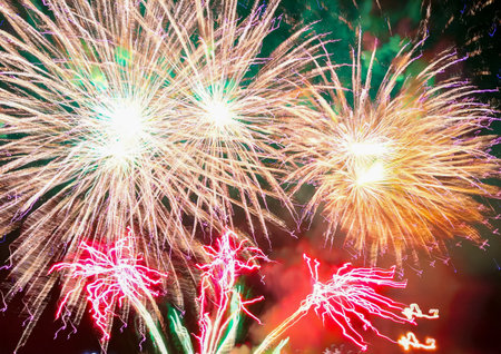 Colorful fireworks of different colors over the night sky during the holiday.の写真素材