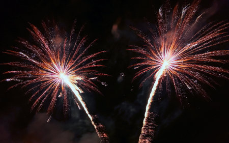 Colorful fireworks of different colors over the night sky during the holiday.の写真素材