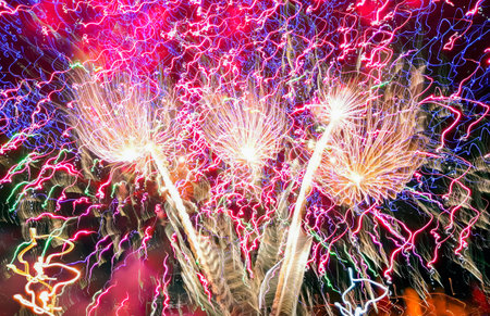 Colorful fireworks of different colors over the night sky during the holiday.の写真素材