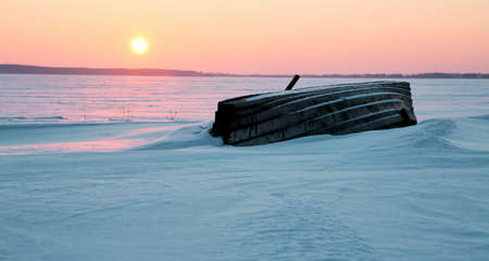 Colorful sunset over the crystal ice of the lake.の写真素材