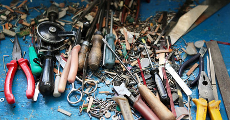 carpentry tools in a pine tree on the table. screws, spare parts for accordion repair.