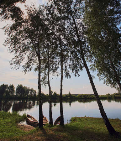 Eastern Europe, Republic of Belarus, Kachanovichi village, Pinsk district, Brest region. River and boats in the summer season.の写真素材
