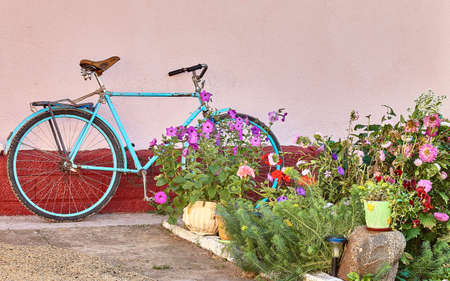 Old bicycle with flowers - ideas for decorating a street or garden.の写真素材