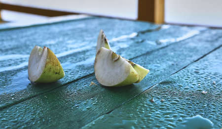 Green apple slices. Apples on a green table.の写真素材
