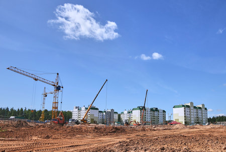Panoramic view of construction sites and many cranes working in a new construction business.の写真素材