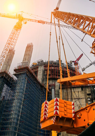 Construction of a nuclear power plant. Tower cranes on the background of the cooling tower.
