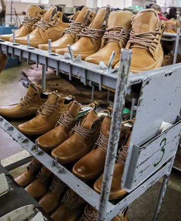 The process of making shoes in a factory. Workshop, assembly line in a shoe factory.