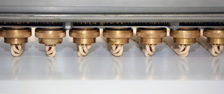 Precision machinery features several nozzles that are actively engaged in a manufacturing process,...