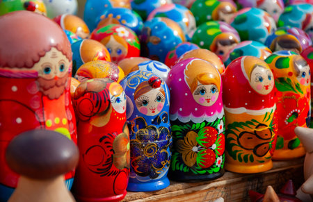 Colorful wooden dolls are beautifully arranged at a market, representing traditional art and culture...