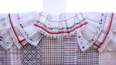 Beautifully crafted textiles with intricate embroidery and patterns are arranged to highlight their...