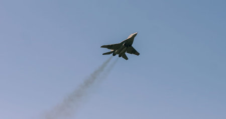 During military exercises in Belarus, advanced fighter jets perform maneuvers in the clear blue sky,...