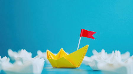 Bright yellow origami boat with a red flag drifts among white paper flowers against a vibrant blue backdrop, showing creativity and playfulness.の素材