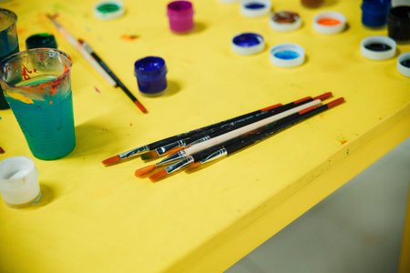 creative mess on the artist's desk at a children's party, soft focus