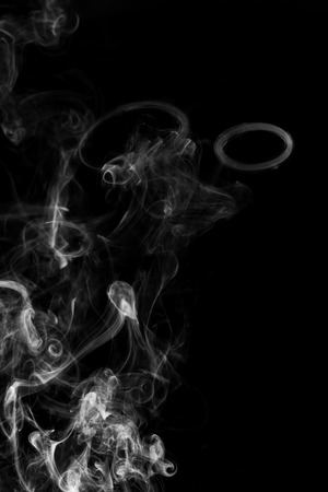 Movement of white smoke isolated on black background.の写真素材