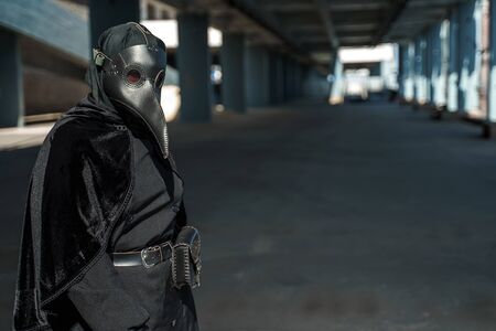 plague doctor in an empty city on an empty marinaの写真素材