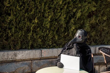 plague doctor holds a tabletの写真素材