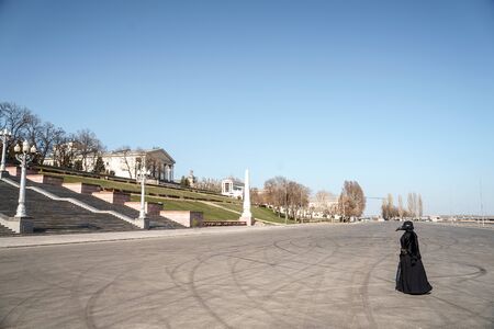 plague doctor alone on a large paved areaの写真素材