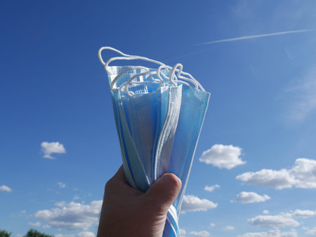 a pack of medical masks against a blue sky