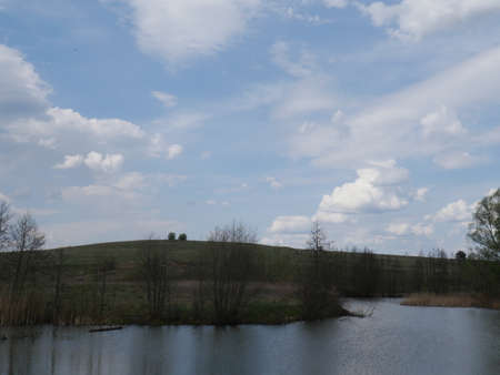 spring river in cloudy weather. Green grassの写真素材