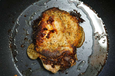 Pork fried in a frying pan. At home. The view from the top.の写真素材