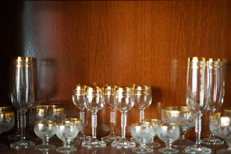 Glass holiday tableware in a mahogany Cabinet.の写真素材