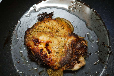 Pork fried in a frying pan. At home. The view from the top.の写真素材